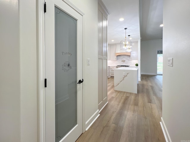 hallway with light hardwood / wood-style flooring