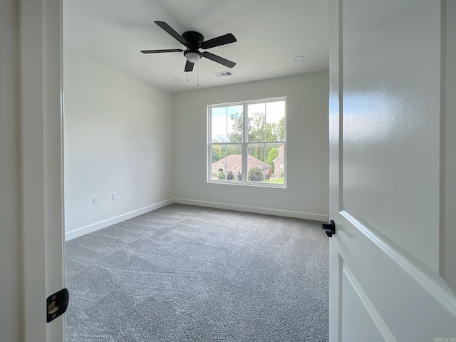 carpeted empty room featuring ceiling fan