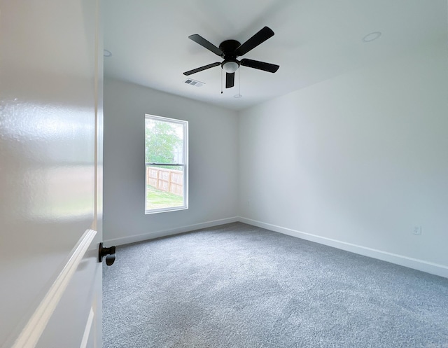 spare room featuring ceiling fan and carpet flooring