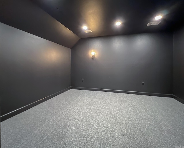 cinema with lofted ceiling and carpet flooring