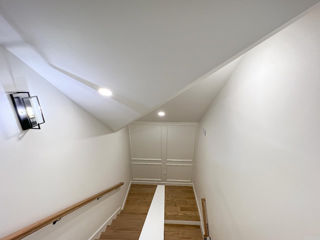 interior space featuring wood-type flooring and lofted ceiling