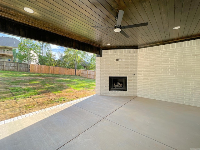 view of patio / terrace featuring an outdoor brick fireplace and ceiling fan