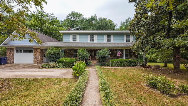 view of front property with a garage and a front lawn