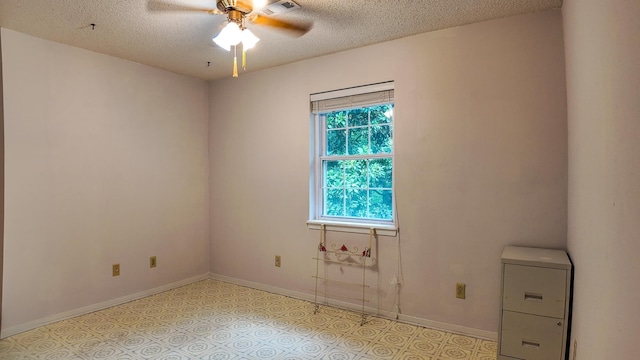 unfurnished room featuring ceiling fan and a textured ceiling