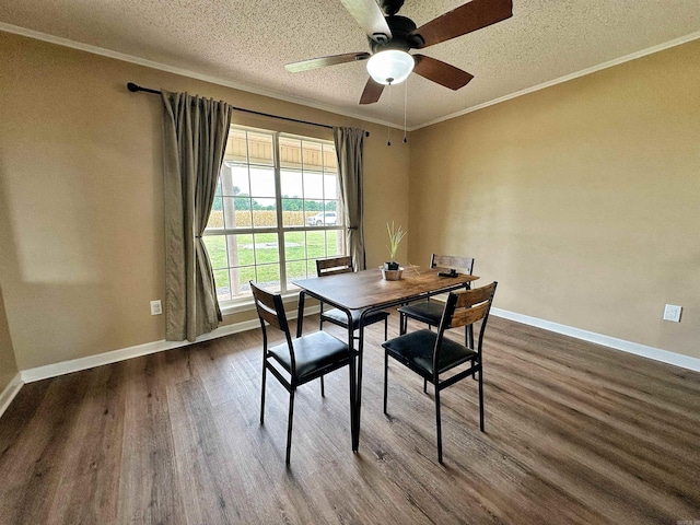 dining room with ceiling fan, a textured ceiling, ornamental molding, and wood-type flooring