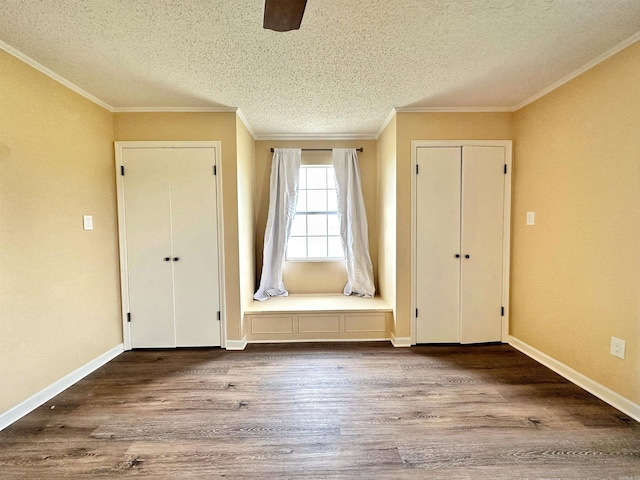 entryway featuring a textured ceiling, crown molding, and hardwood / wood-style flooring