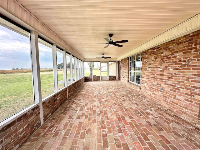 unfurnished sunroom with ceiling fan and wood ceiling