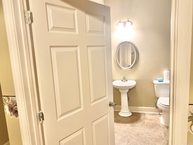 bathroom with toilet and tile patterned flooring