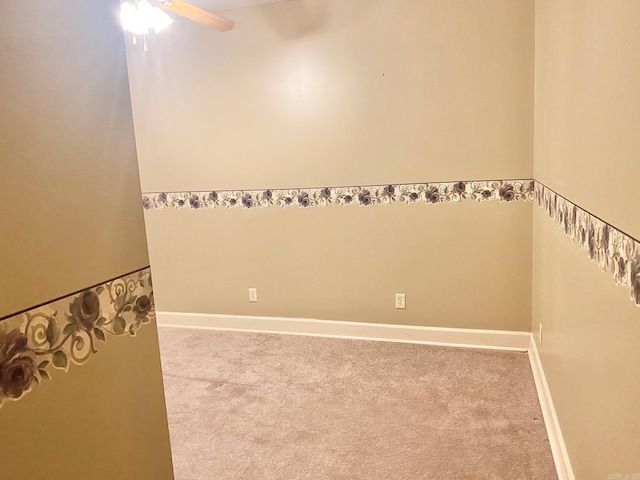 carpeted spare room featuring ceiling fan