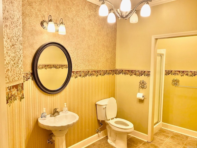 bathroom with a shower with shower door, toilet, tile patterned floors, a chandelier, and ornamental molding