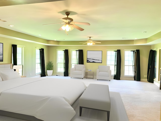 bedroom featuring ceiling fan, carpet flooring, and multiple windows