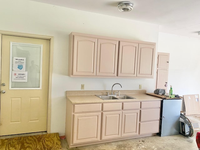 kitchen with sink and light brown cabinetry