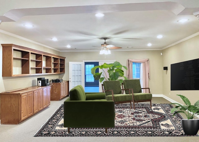 carpeted living room featuring ceiling fan and ornamental molding