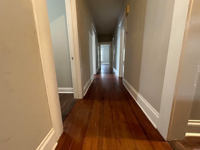 hallway with hardwood / wood-style floors