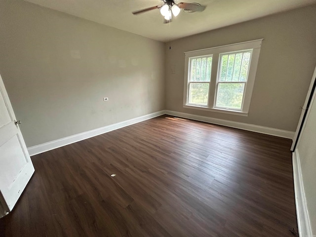 unfurnished room with dark hardwood / wood-style flooring and ceiling fan