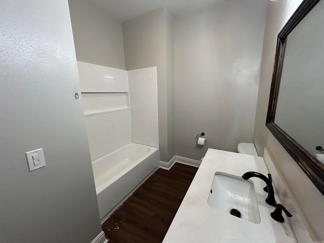 full bathroom with shower / washtub combination, wood-type flooring, vanity, and toilet