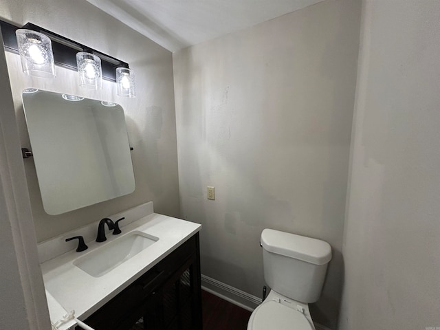 bathroom featuring toilet and vanity