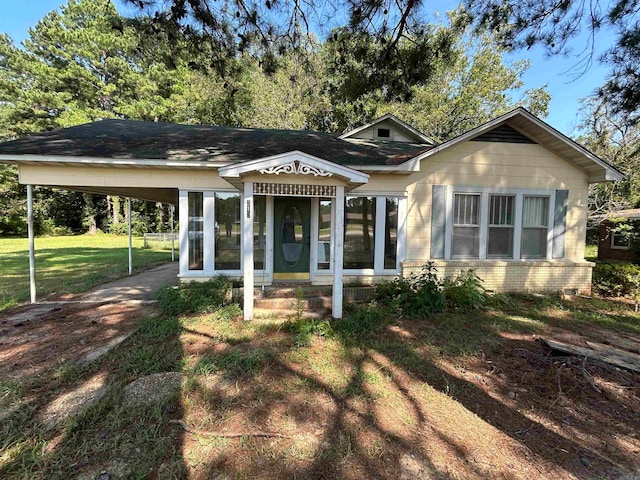 view of front facade with a front yard and a carport