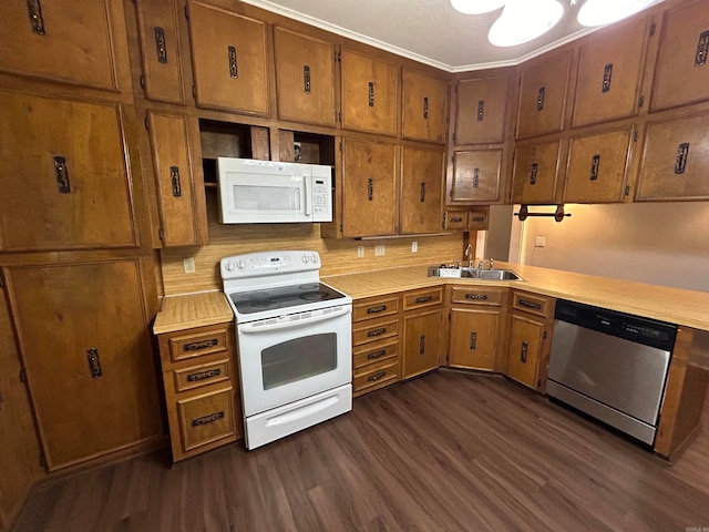 kitchen with white appliances, sink, and dark hardwood / wood-style flooring