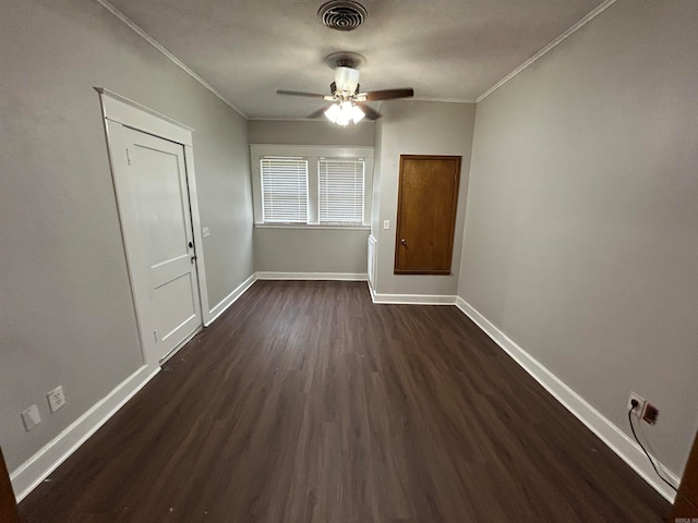 unfurnished room with ceiling fan, dark hardwood / wood-style floors, and ornamental molding