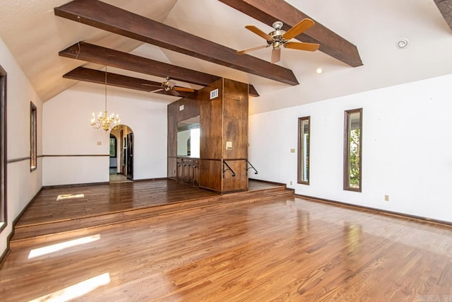 spare room with lofted ceiling with beams, arched walkways, wood finished floors, and ceiling fan with notable chandelier