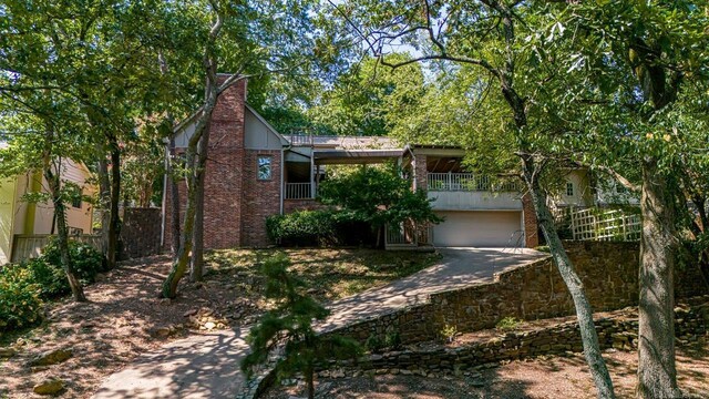 view of front of home featuring a garage and a balcony