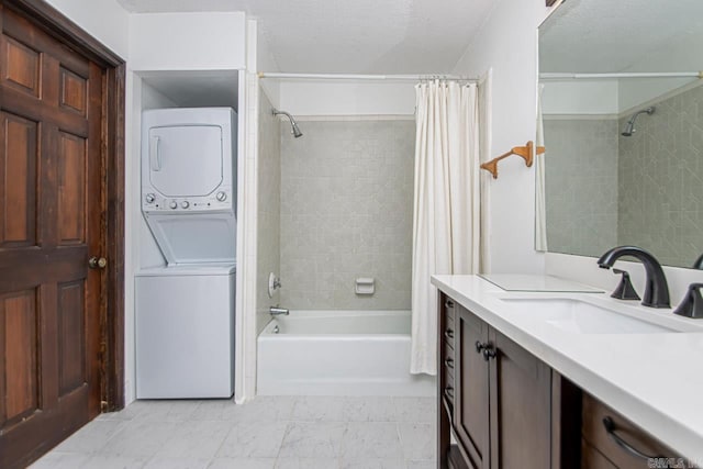 bathroom featuring shower / bath combo, stacked washer and clothes dryer, vanity, and a textured ceiling