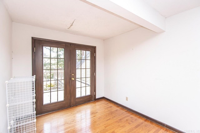 doorway to outside with french doors, light wood-style flooring, and baseboards