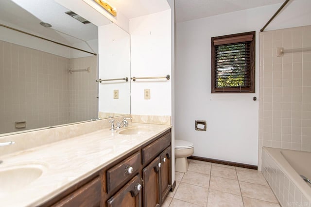 full bathroom featuring double vanity, baseboards, toilet, tile patterned flooring, and a sink