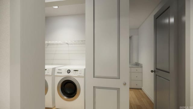 clothes washing area featuring light hardwood / wood-style flooring