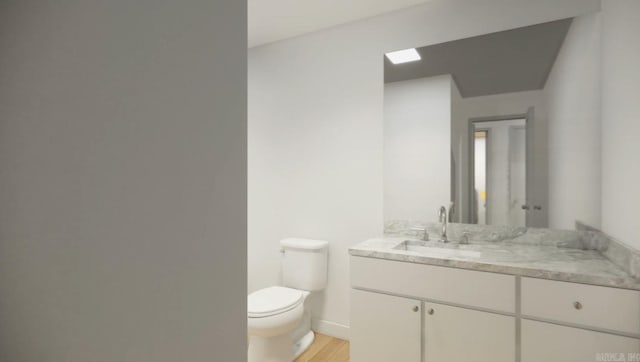 bathroom featuring vanity, toilet, and hardwood / wood-style flooring