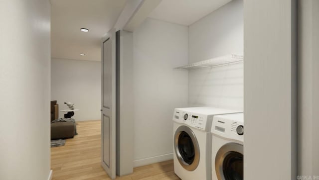 laundry room with light hardwood / wood-style flooring and separate washer and dryer