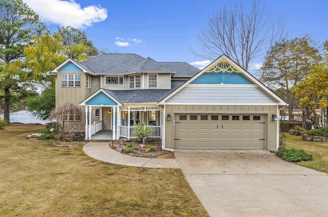 view of front of property with a porch, board and batten siding, a front yard, a garage, and driveway