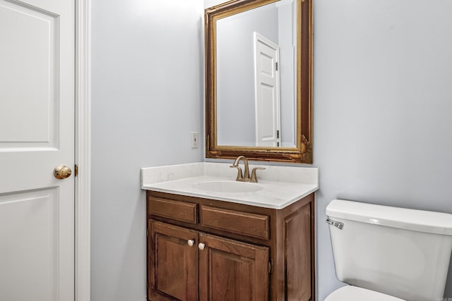 half bath featuring toilet and vanity