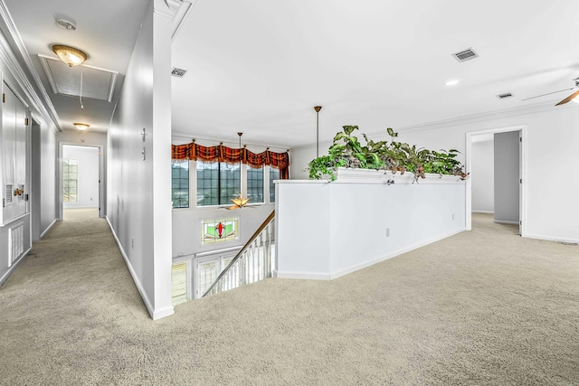 hall with visible vents, attic access, light carpet, an upstairs landing, and baseboards