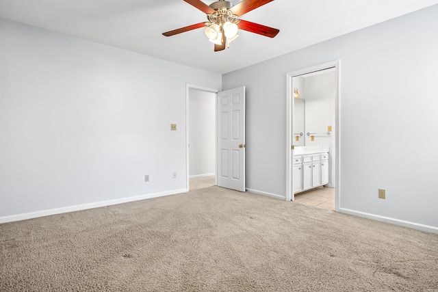 unfurnished bedroom featuring a ceiling fan, light colored carpet, connected bathroom, and baseboards