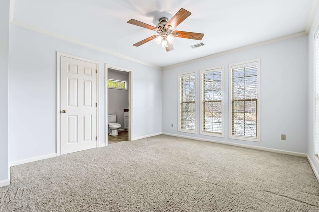 unfurnished bedroom with ornamental molding, baseboards, visible vents, and carpet flooring