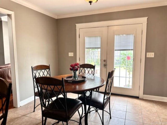 dining area featuring light tile patterned floors, french doors, and crown molding