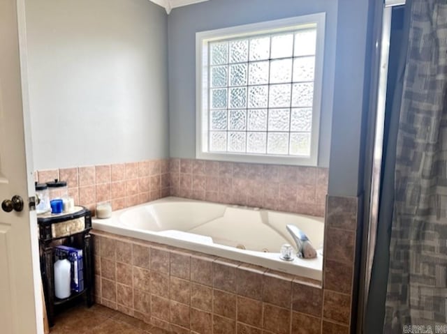 bathroom with tile patterned floors and a relaxing tiled tub