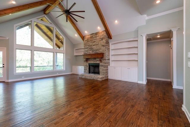 unfurnished living room featuring a stone fireplace, crown molding, high vaulted ceiling, dark hardwood / wood-style floors, and beam ceiling