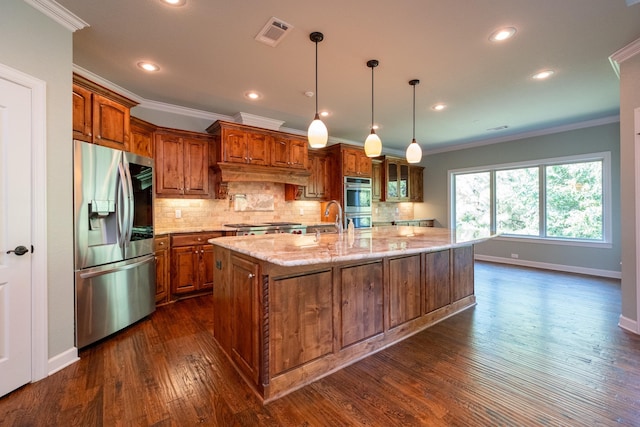 kitchen with hanging light fixtures, crown molding, stainless steel appliances, and a spacious island