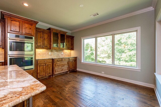 kitchen featuring double oven, decorative backsplash, dark wood-type flooring, and ornamental molding