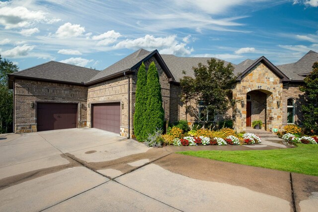 french country style house featuring a garage