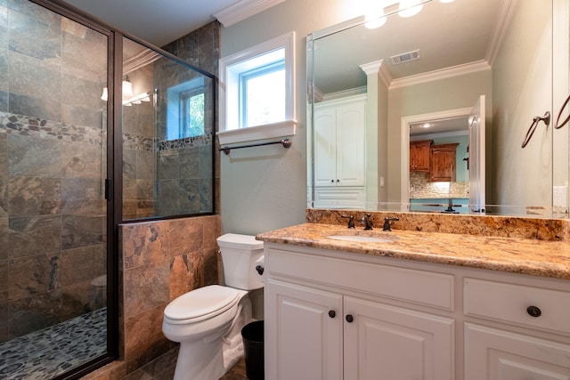 bathroom featuring vanity, crown molding, a shower with door, and toilet