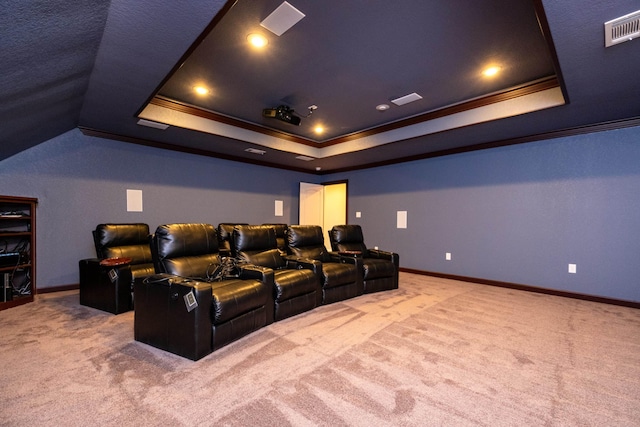 cinema room featuring crown molding, a tray ceiling, and carpet floors