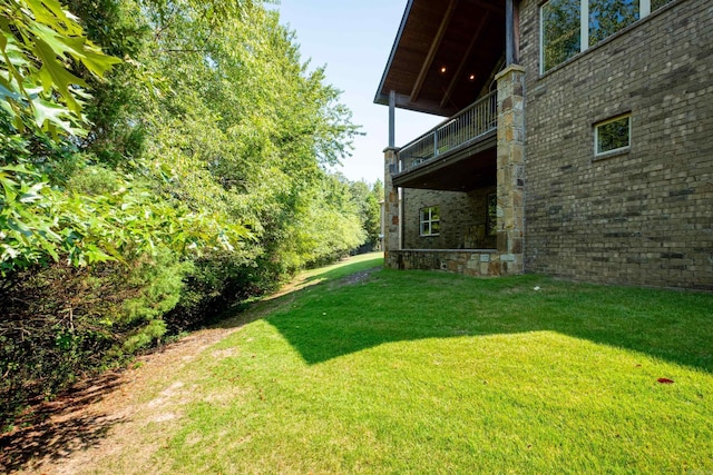 view of yard with a balcony