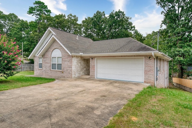 view of front of home featuring a garage and a front lawn