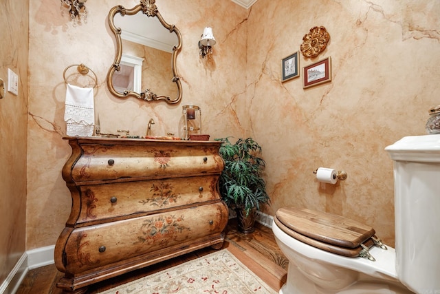 bathroom with toilet, hardwood / wood-style flooring, and crown molding