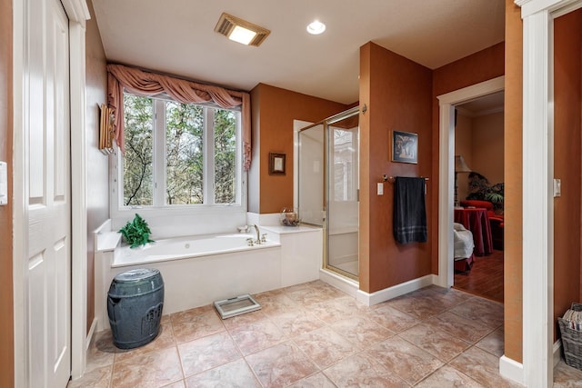 bathroom with tile patterned flooring and separate shower and tub