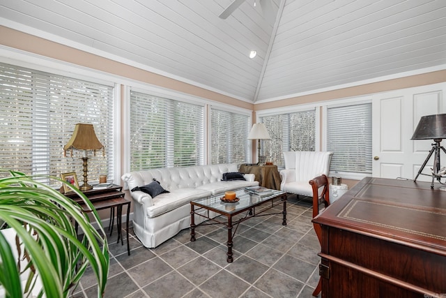 living room with dark tile patterned flooring and high vaulted ceiling